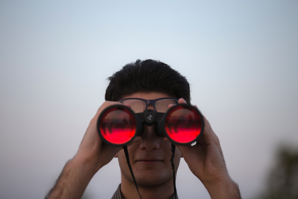 Man looking through binoculars